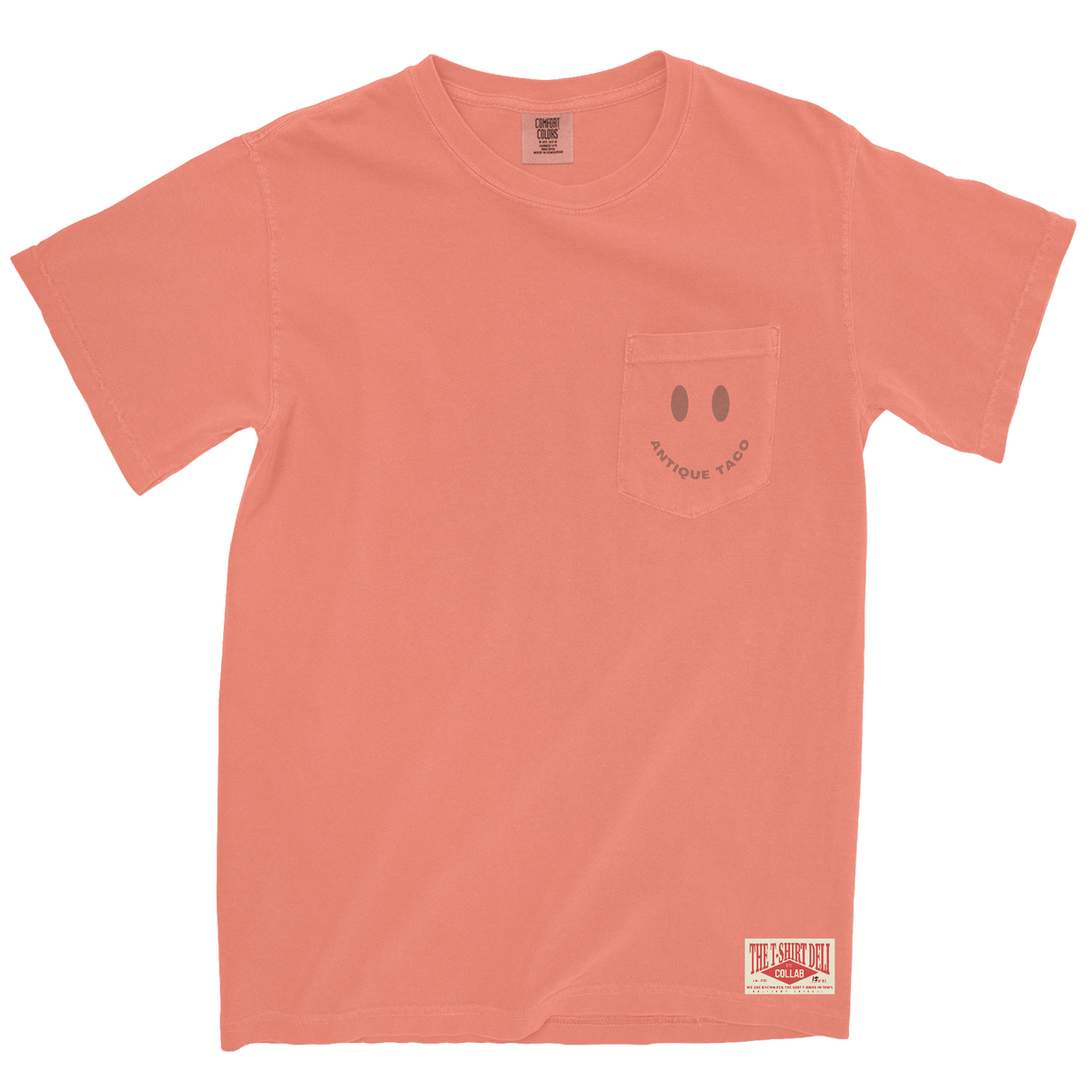 Coral t-shirt with a smiley face design on the pocket